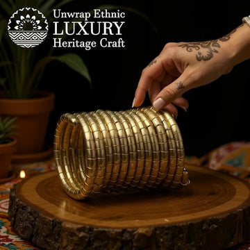 Traditional brass bangles with an antique finish, arranged on a wooden surface, hand held, featuring an openable kada style.