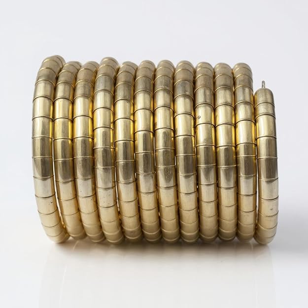 Set of Dajinn Eternal Grace brass bangles with a glossy gold finish, featuring sleek coil design for adjustable fit.